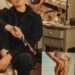 Une artiste peintre, jeune et dynamique, posant devant une de ses toiles dans son atelier